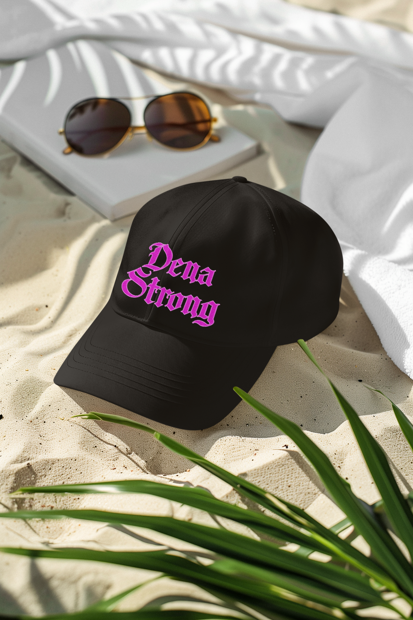 Dena Strong black dad hat with bright pink embroidered gothic lettering